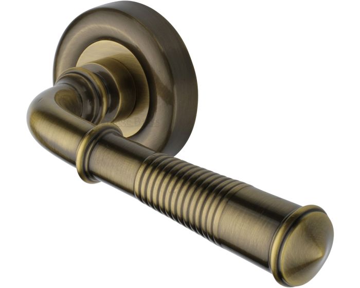 Colonial Reeded Lever Handle On Round Rose Antique Brass Gloss Lacquered G Johns And Sons 8072